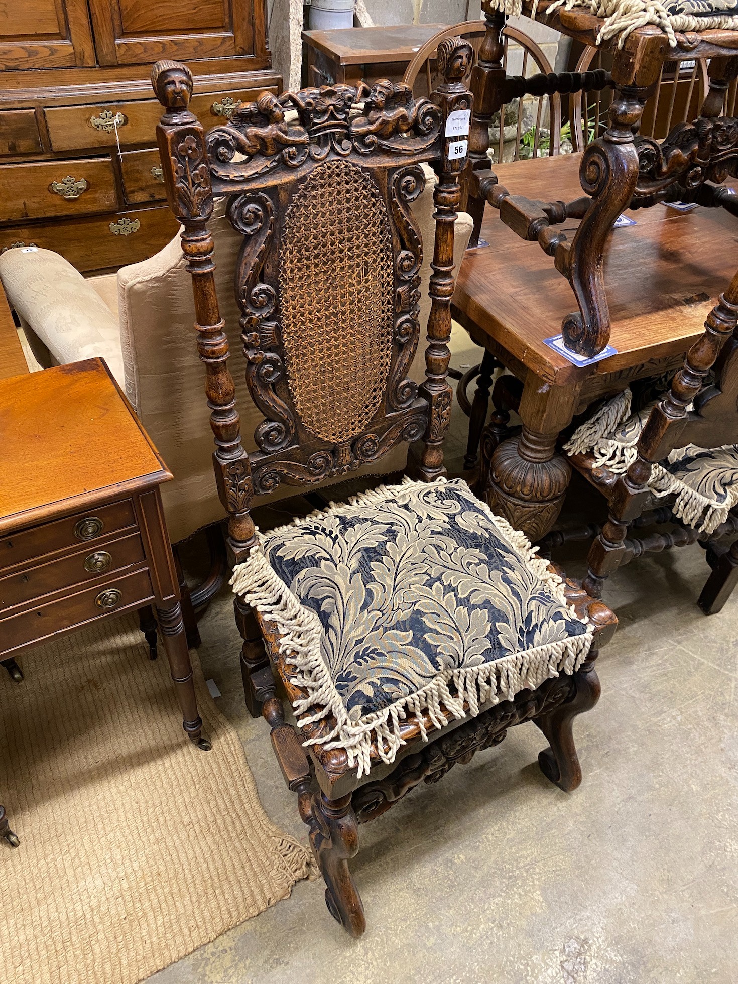 A set of six Carolean style caned oak dining chairs, width 54cm, depth 46cm, height 121cm